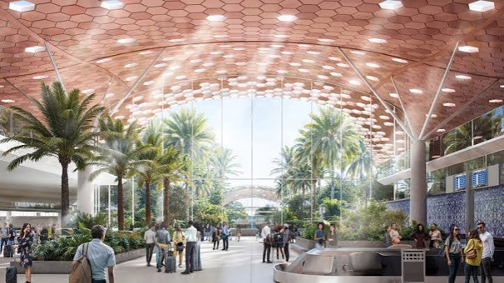 Architectural rendering of the proposed Mohammed V Airport new terminal interior, showing a hexagonal-patterned ceiling, palm trees and passengers walking through a glazed concourse.